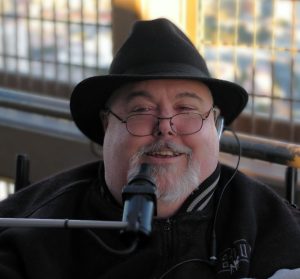 Photo of Guy W Thomas, wearing a black hat and glasses
